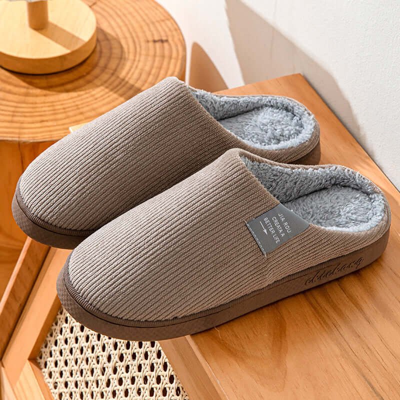 Home Indoor Wear-resistant Non Slip Cotton Slippers in soft brown with plush lining on a wooden surface.